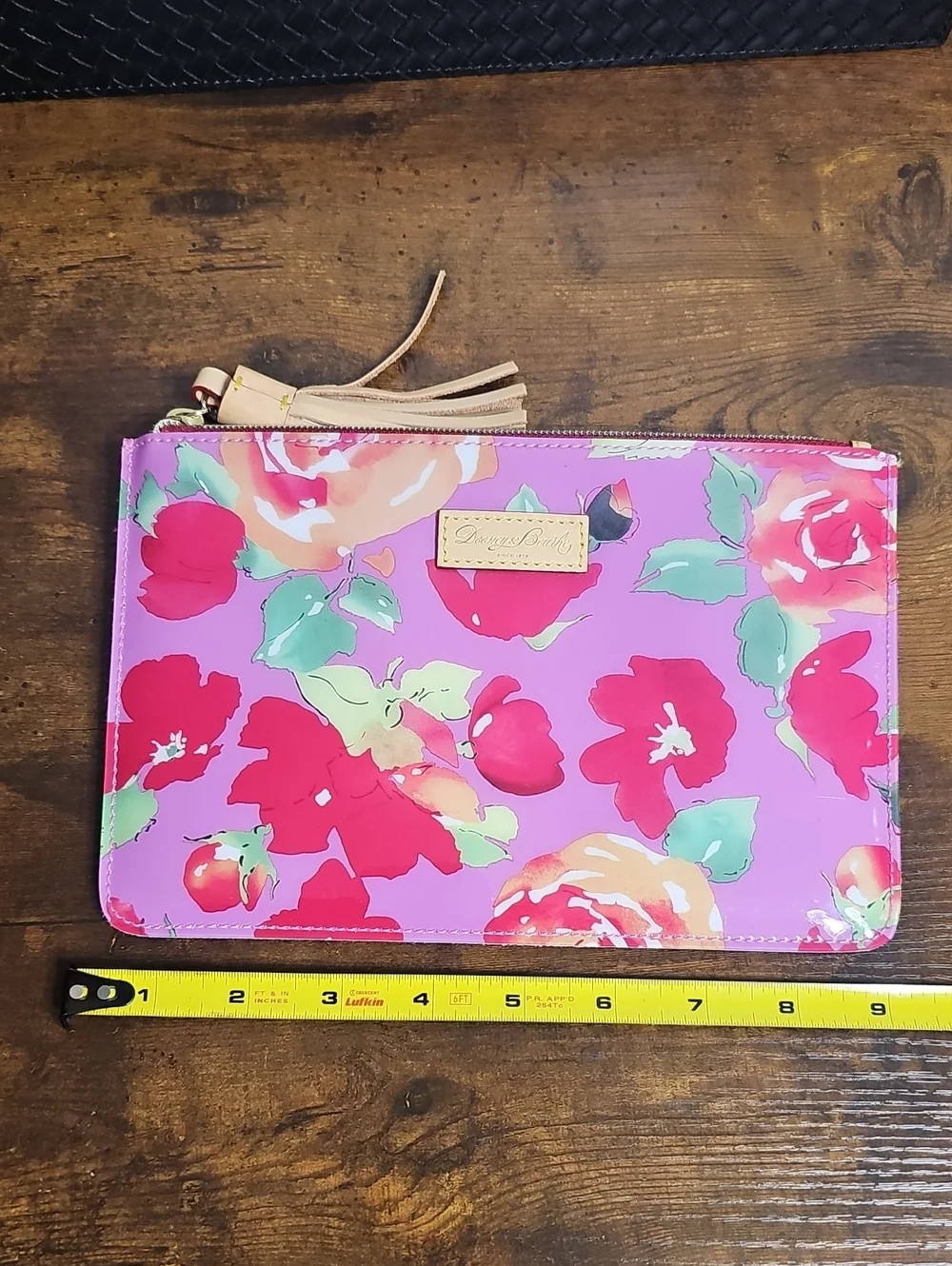 Dooney And Bourke Vinyl And Leather Floral Zip Clutch with Tassel